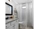 Well-lit bathroom featuring granite counters, framed mirror, and tiled shower and floors at 275 Crowe Springs Nw Rd, Cartersville, GA 30121