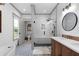 Bright bathroom featuring white shiplap walls, patterned tile floors, and a frameless glass shower with bench at 275 Crowe Springs Nw Rd, Cartersville, GA 30121