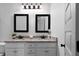 Bathroom featuring double sinks with granite countertops and decorative framed mirrors at 275 Crowe Springs Nw Rd, Cartersville, GA 30121
