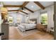 Spacious bedroom with vaulted ceilings, exposed wood beams, and ample natural light at 275 Crowe Springs Nw Rd, Cartersville, GA 30121