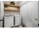 Laundry room with modern washer and dryer, utility sink and open shelving at 275 Crowe Springs Nw Rd, Cartersville, GA 30121