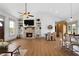 Well-lit living space with a brick fireplace, built-in bookshelves, and an open-concept dining area at 275 Crowe Springs Nw Rd, Cartersville, GA 30121
