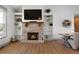 Open living space with a cozy fireplace, custom built-ins, and view to the dining area at 275 Crowe Springs Nw Rd, Cartersville, GA 30121