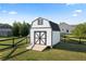 White storage shed with black trim sits on a flatbed in a large fenced in backyard at 275 Crowe Springs Nw Rd, Cartersville, GA 30121