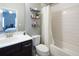 Bright bathroom featuring a white vanity, toilet, and a tub with a white tile surround at 4280 Castlewood Rd, Cumming, GA 30040