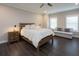 Light-filled bedroom with a wooden bed frame, a loveseat, and neutral colors at 4280 Castlewood Rd, Cumming, GA 30040
