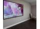 Modern bedroom design featuring a large screen TV and a cozy accent chair on hardwood floors at 4280 Castlewood Rd, Cumming, GA 30040