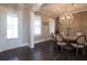 Charming dining room featuring a rustic wood table, decorative lighting, and wood accent wall at 4280 Castlewood Rd, Cumming, GA 30040