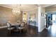Elegant dining room featuring wood floors, modern chandelier, neutral colors, table with seating for six at 4280 Castlewood Rd, Cumming, GA 30040