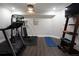 Home gym area featuring a treadmill, free weights, and a mounted television at 4280 Castlewood Rd, Cumming, GA 30040