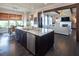 Open kitchen with granite countertops and large island that connects to a dining area and living room at 4280 Castlewood Rd, Cumming, GA 30040