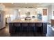 Open kitchen features an island with seating, stainless steel appliances, and ample counter space at 4280 Castlewood Rd, Cumming, GA 30040