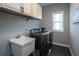 Well-equipped laundry room with modern appliances, ample cabinet space, and a utility sink at 4280 Castlewood Rd, Cumming, GA 30040
