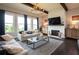 Comfortable living room featuring dark wood floors, stylish furnishings, fireplace, and large windows at 4280 Castlewood Rd, Cumming, GA 30040