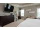 Large primary bedroom with a dresser, sofa, and plenty of natural light from the windows at 4280 Castlewood Rd, Cumming, GA 30040
