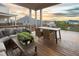 Spacious outdoor patio area with seating, a table, green accents, and a beautiful sky view at 4280 Castlewood Rd, Cumming, GA 30040