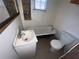 Small bathroom featuring a white sink, toilet, and a vintage clawfoot bathtub at 6475 Church St, Atlanta, GA 30291