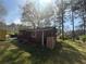 A view of the house exterior, showing the side of the home, green lawn, and blue sky at 6475 Church St, Atlanta, GA 30291