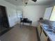 Functional kitchen with white cabinets, a stainless steel sink, and tiled floors at 6475 Church St, Atlanta, GA 30291
