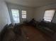 The living room includes couches, windows, door, and personal items at 6475 Church St, Atlanta, GA 30291
