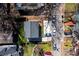 Birds eye view of a home with a driveway, surrounded by mature trees and neighboring houses along a street at 1051 Curran Nw St, Atlanta, GA 30318