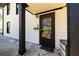 Close up of the front door with black frame, a house number, and a porch light at 1051 Curran Nw St, Atlanta, GA 30318