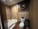 Bathroom featuring a tub, tile walls, toilet, and decorative wreath at 5925 Tortosa Pl, Atlanta, GA 30349