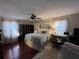Bedroom featuring a bed, hardwood floors, ceiling fan, desk and natural light at 5925 Tortosa Pl, Atlanta, GA 30349