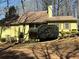 Charming yellow two-story home with wood shutters and mature landscaping at 5925 Tortosa Pl, Atlanta, GA 30349
