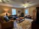 Comfortable living room with leather furniture, area rug, and natural lighting at 5925 Tortosa Pl, Atlanta, GA 30349