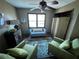 Cozy sitting area with natural light, ceiling fan, art decorations, and comfortable seating at 5925 Tortosa Pl, Atlanta, GA 30349