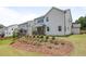 View of the home's backyard and back porch and a landscaped hillside at 2436 Hidden Creek Road, Kennesaw, GA 30152