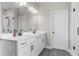 Bathroom featuring double sink vanity, modern lighting, and a glass-enclosed shower at 2436 Hidden Creek Road, Kennesaw, GA 30152