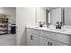 Bathroom with a double sink vanity, white cabinets, and black hardware at 2436 Hidden Creek Road, Kennesaw, GA 30152