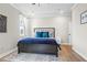 Cozy bedroom featuring a large bed, stylish rug, and natural light from the window at 2436 Hidden Creek Road, Kennesaw, GA 30152