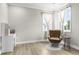 Relaxing bedroom has a reading chair and desk in a sunlit area at 2436 Hidden Creek Road, Kennesaw, GA 30152
