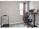 Simple home office with a large gaming chair, monitors, and a small treadmill at 2436 Hidden Creek Road, Kennesaw, GA 30152