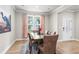 Well-lit dining room with hardwood floors, modern decor, and a view of the outdoors at 2436 Hidden Creek Road, Kennesaw, GA 30152