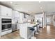 Modern kitchen features white cabinets, stainless steel appliances, and a large center island at 2436 Hidden Creek Road, Kennesaw, GA 30152