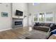 Spacious living room with modern fireplace, ample natural light, and cozy sectional sofa at 2436 Hidden Creek Road, Kennesaw, GA 30152
