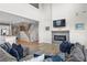 Comfortable living room features a fireplace, open staircase, and seamless flow into the kitchen at 2436 Hidden Creek Road, Kennesaw, GA 30152