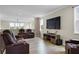 Spacious living room with wood-look floors and reclining leather seating at 2436 Hidden Creek Road, Kennesaw, GA 30152