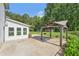 Spacious backyard featuring a covered patio, lush green lawn, and mature trees, great for outdoor entertaining at 3880 Dial Mill Ne Rd, Conyers, GA 30013