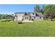 Expansive backyard view features a covered patio, well maintained lawn, and white two story home at 3880 Dial Mill Ne Rd, Conyers, GA 30013