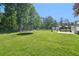 Expansive backyard features a trampoline, chicken coop, and a covered patio at 3880 Dial Mill Ne Rd, Conyers, GA 30013