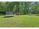 Backyard features a chicken coop and trampoline and lots of green space at 3880 Dial Mill Ne Rd, Conyers, GA 30013