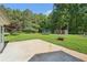 Lush backyard with a patio, trampoline, and mature trees at 3880 Dial Mill Ne Rd, Conyers, GA 30013