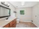 Bright bathroom featuring a single sink vanity with a large mirror and tiled floors at 3880 Dial Mill Ne Rd, Conyers, GA 30013