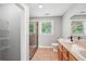 Bathroom featuring walk-in shower, double sink vanity, tile floors, and a window view at 3880 Dial Mill Ne Rd, Conyers, GA 30013