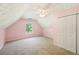 This carpeted bedroom with pink walls has a ceiling fan, window, and closet at 3880 Dial Mill Ne Rd, Conyers, GA 30013